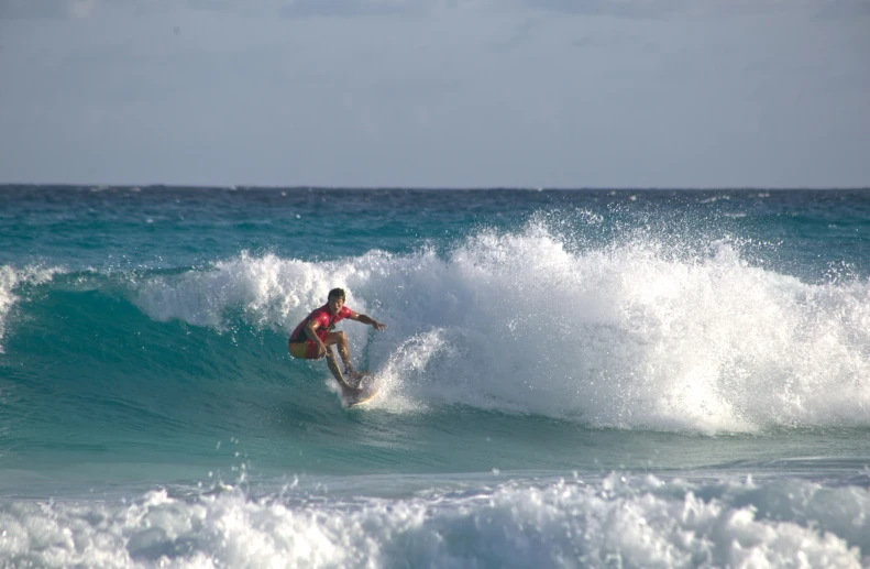 a man that is surfing in some water