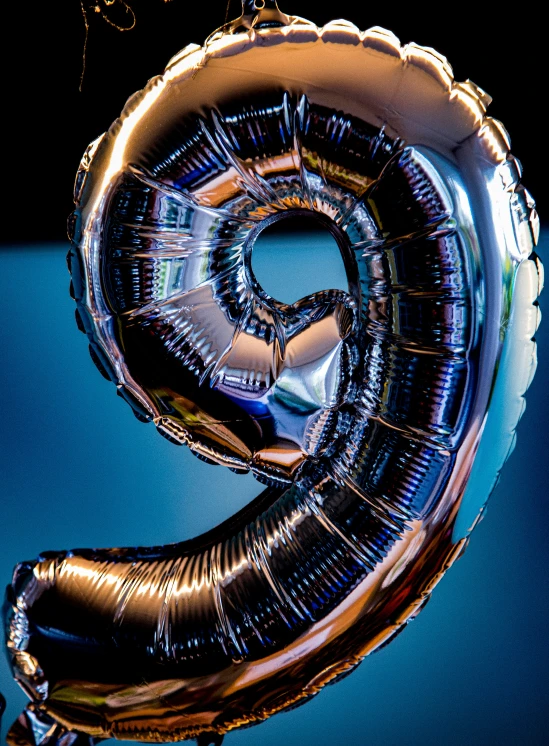 a giant foil balloon shaped like the letter g