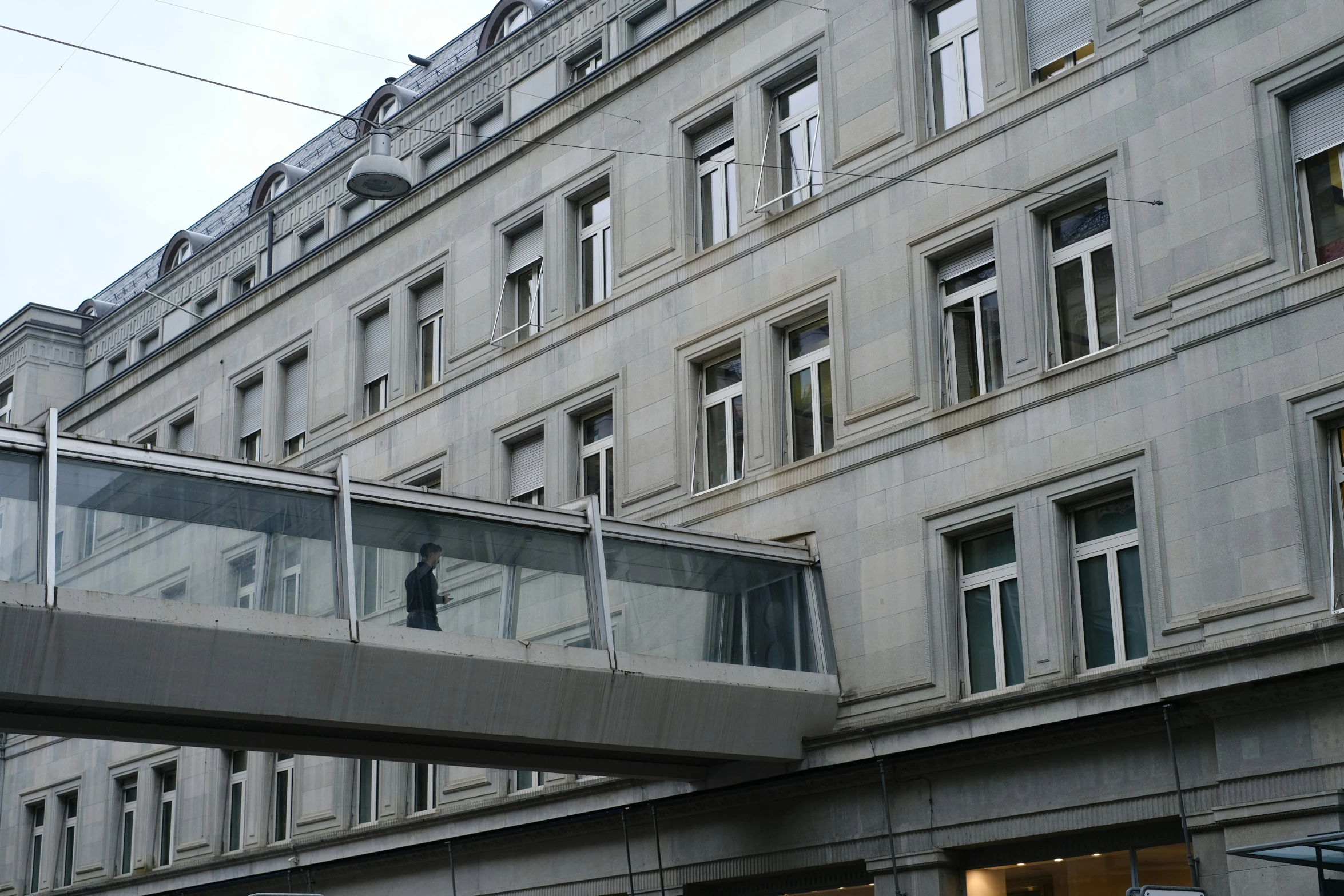 a balcony above a walkway between buildings