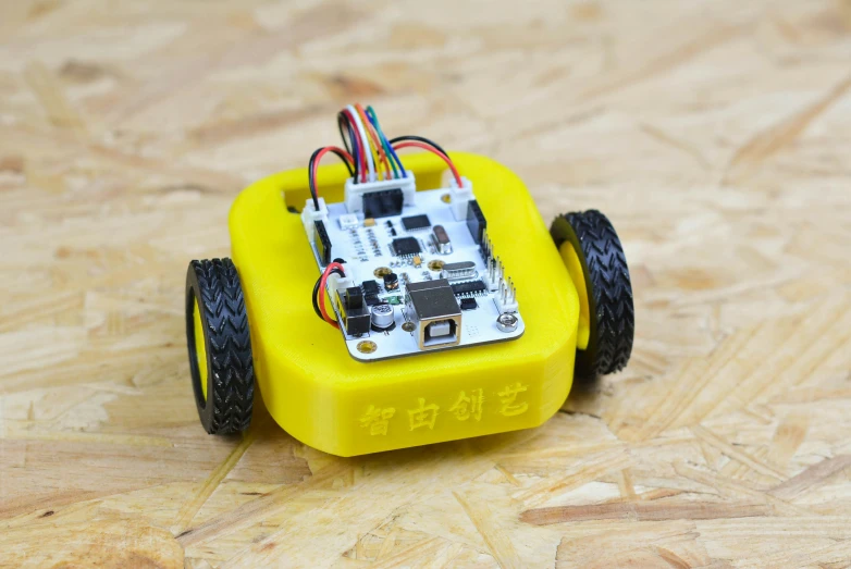 a yellow remote controlled toy car with wires