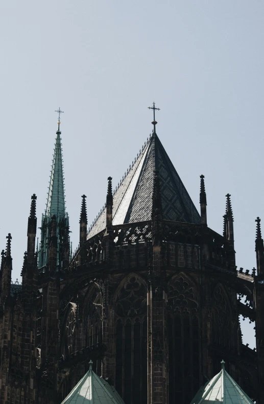 the sky is blue and hazy and the tower of a church is almost all black