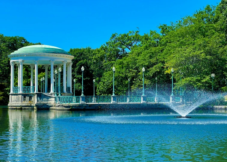 the gazebo stands tall over the beautiful pond