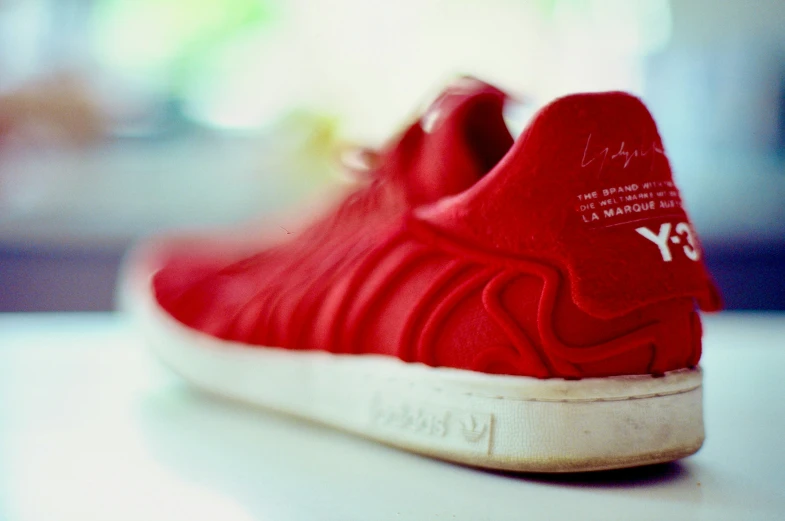 a close up s of a red adidas sneaker