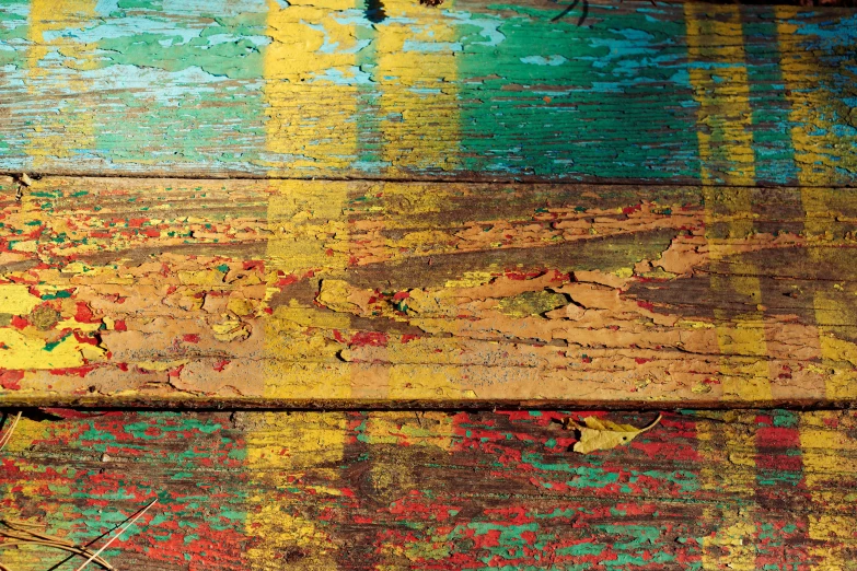 yellow green and red paint painted on wood