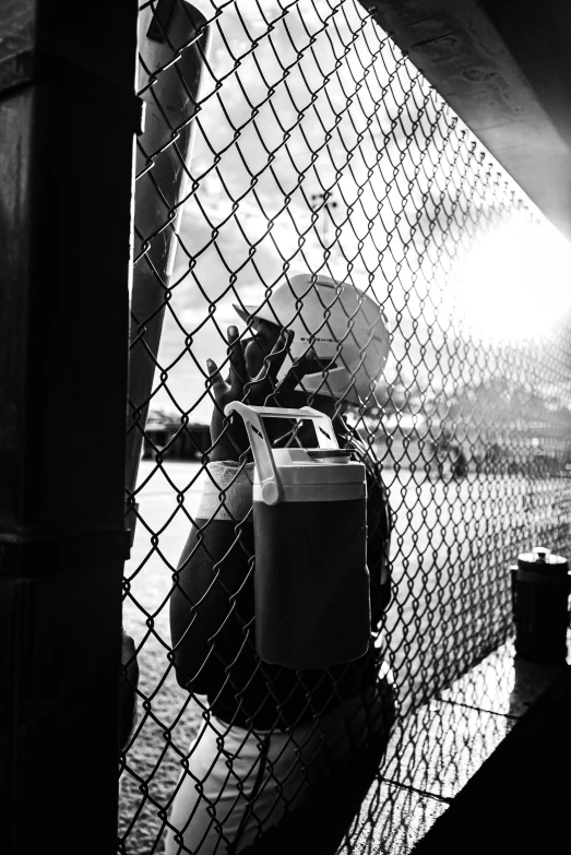 a black and white po of some stuff behind a chain link fence