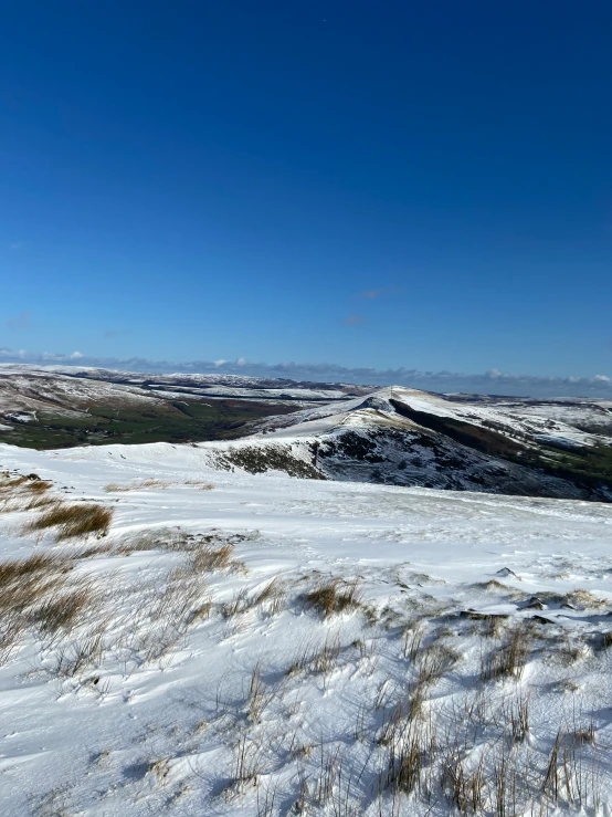 a large expanse with snow covered ground and a hill on the horizon