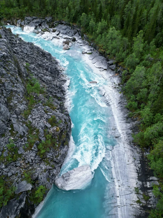 an aerial s of a river flowing through trees