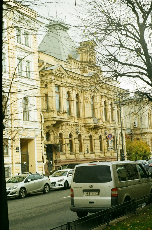 an old building stands on a corner in the middle of a street