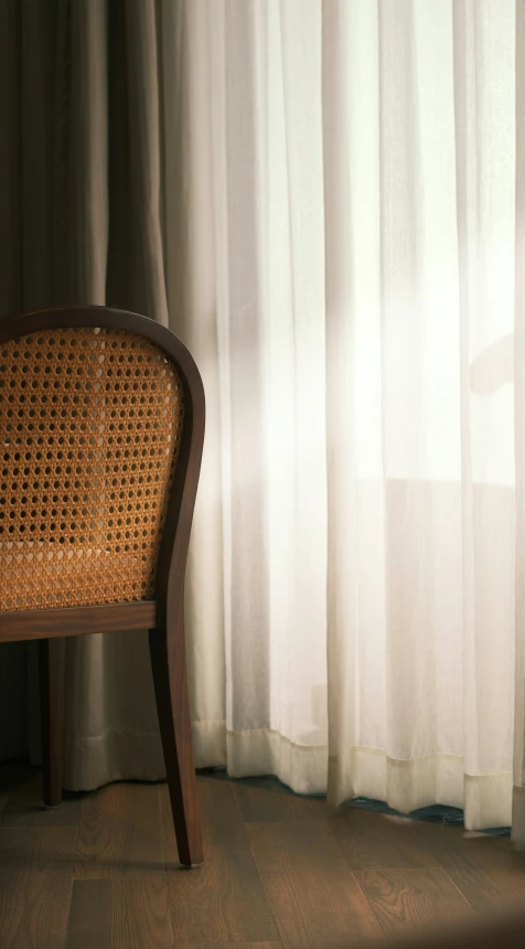 a wicker chair is positioned next to the window