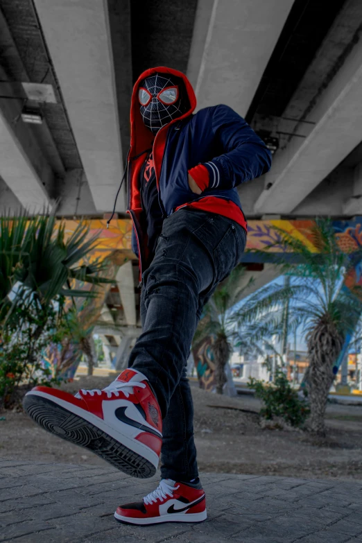 an athletic man is doing tricks under an overpass