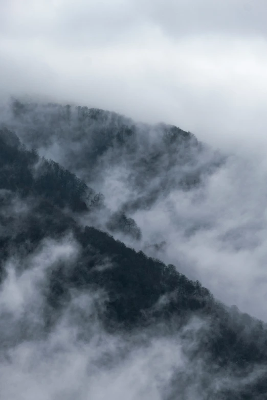 a airplane flies through the air above a mountain