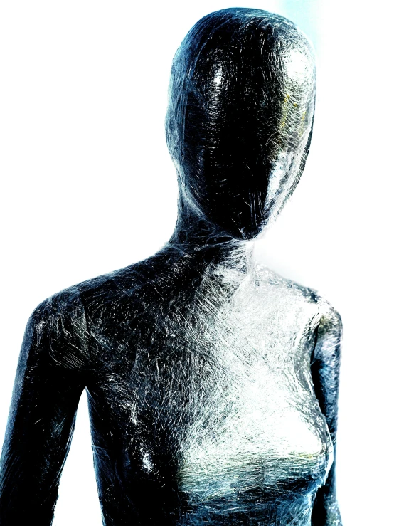 the dark woman with a metallic body looks into the distance