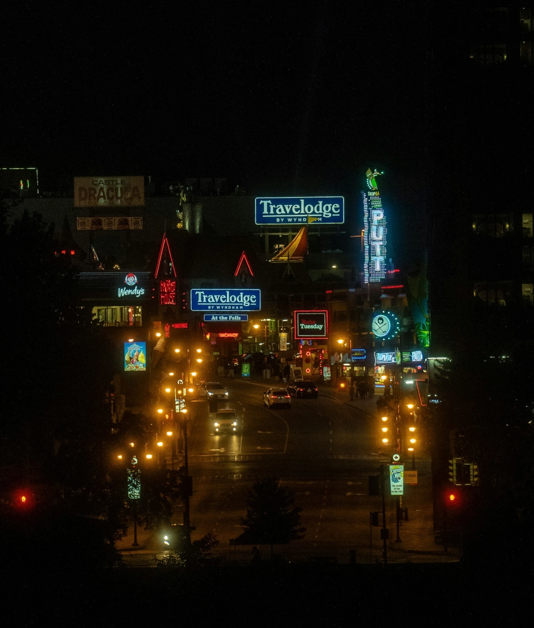 an intersection of an urban city at night