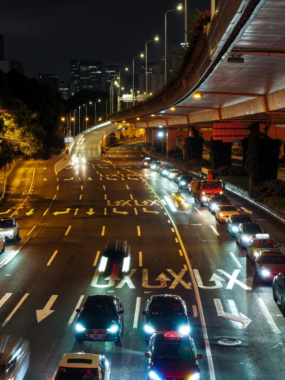 a street filled with lots of traffic at night