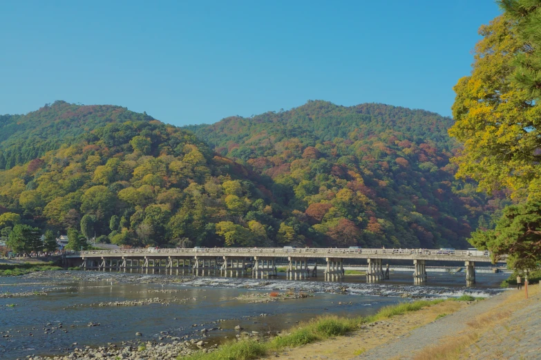 an image of a bridge going across the water