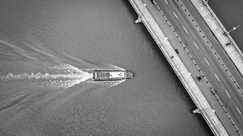 black and white pograph of a boat traveling on the water