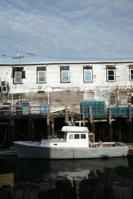 a white boat floating in front of a dock