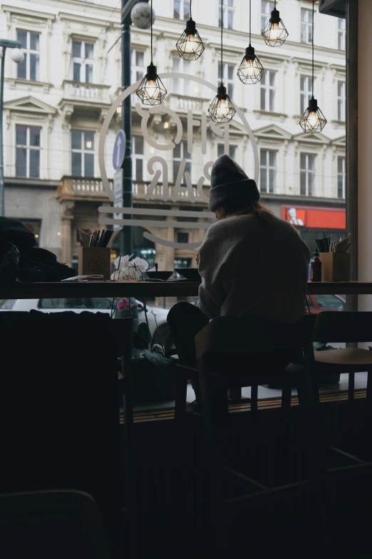 the woman is sitting alone at the table