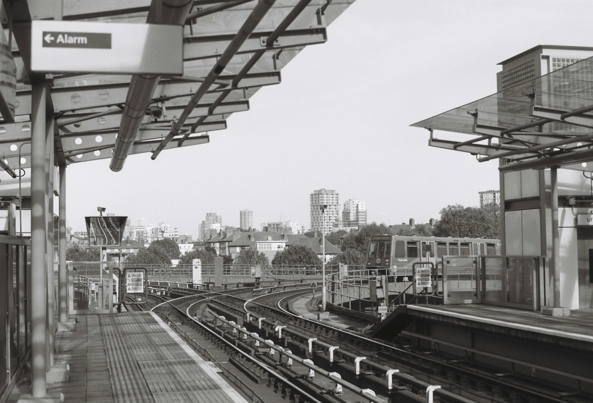 there is an old po looking down the train tracks at the station