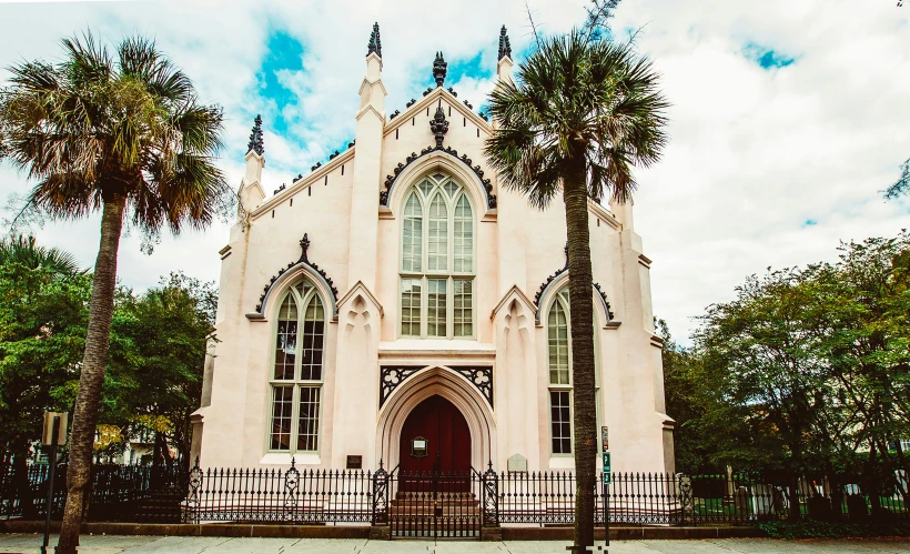 a church with a big door and several trees