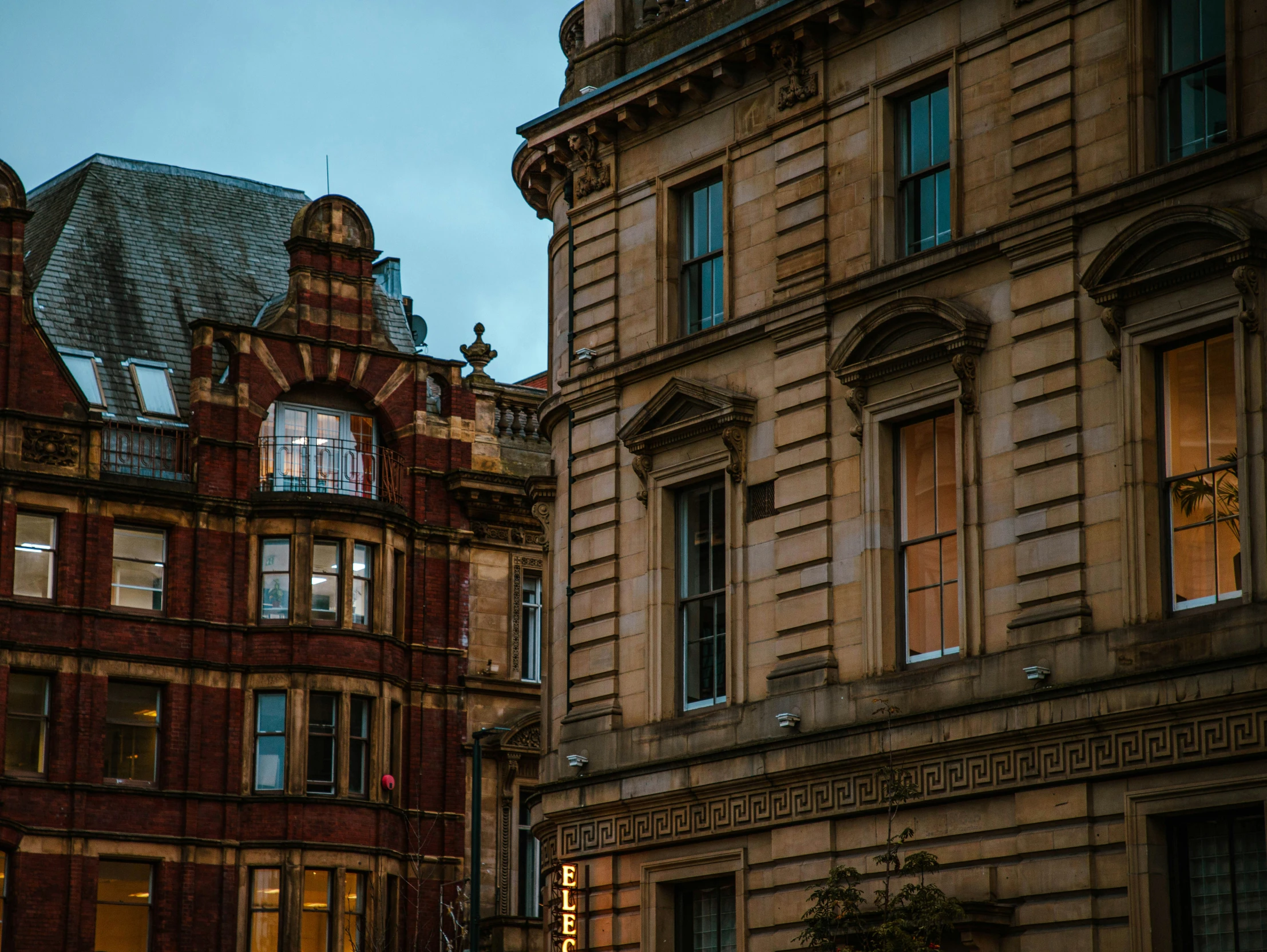 the front and side of old buildings that are tan