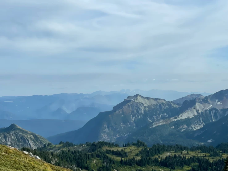 some very pretty mountains by some green grass