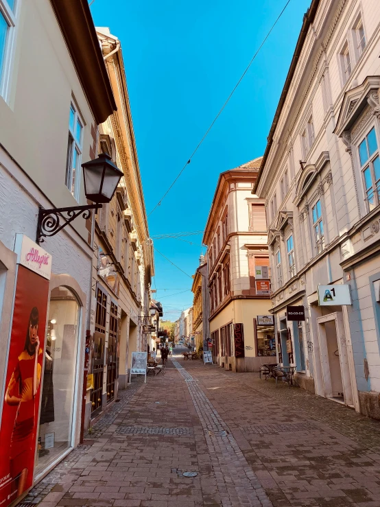 an empty street leading into a town