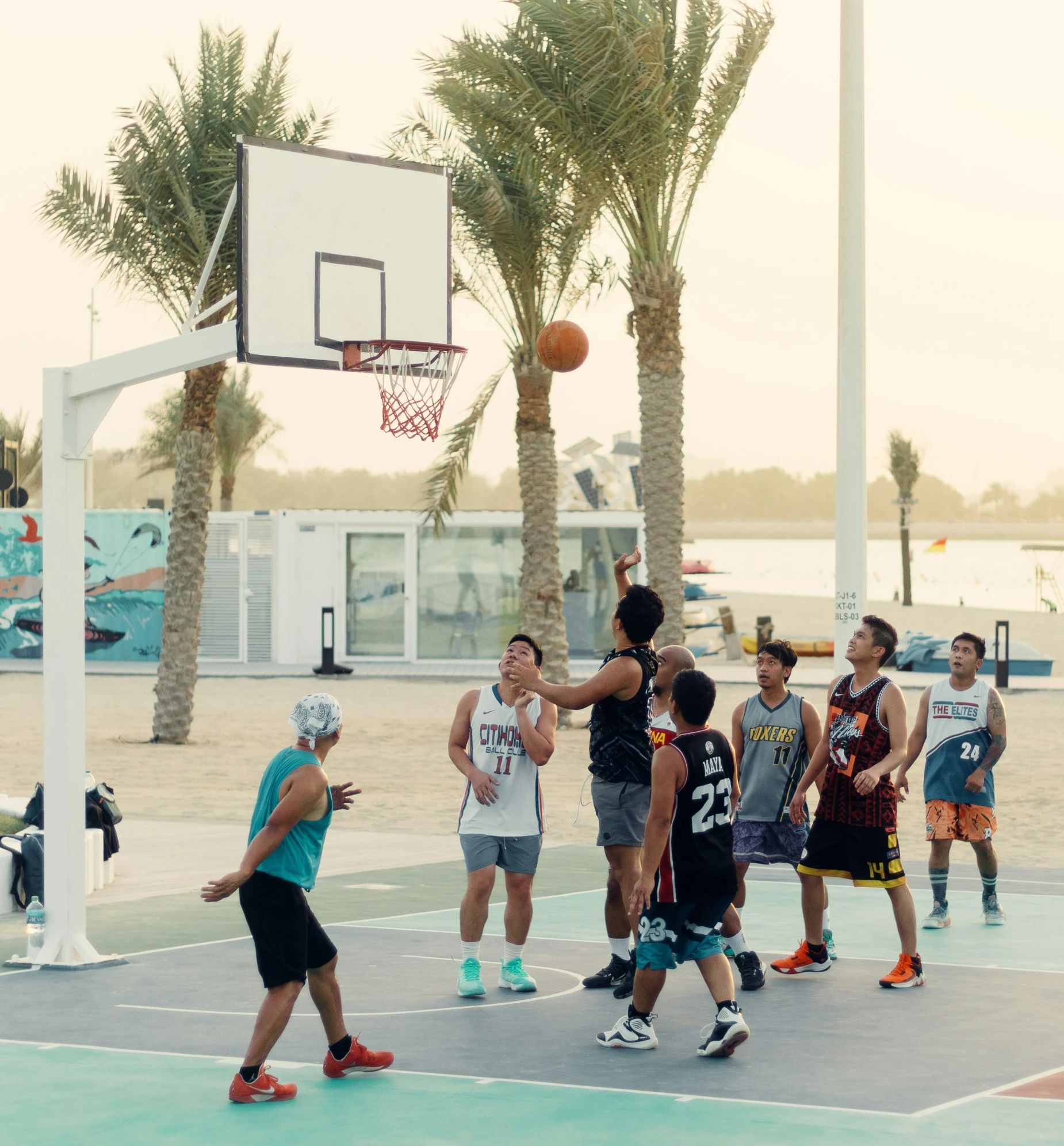 a group of young men playing basketball on a court