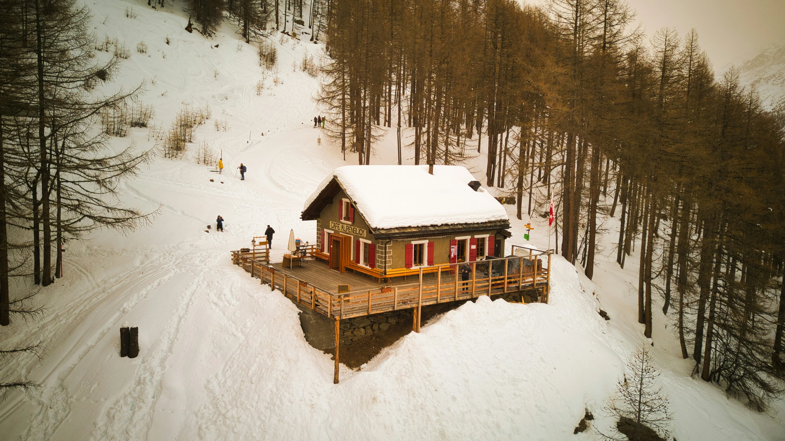 small cabin built in the snow surrounded by trees