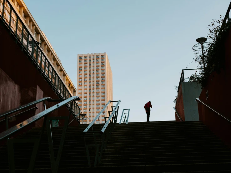 a man stands on the top of some stairs