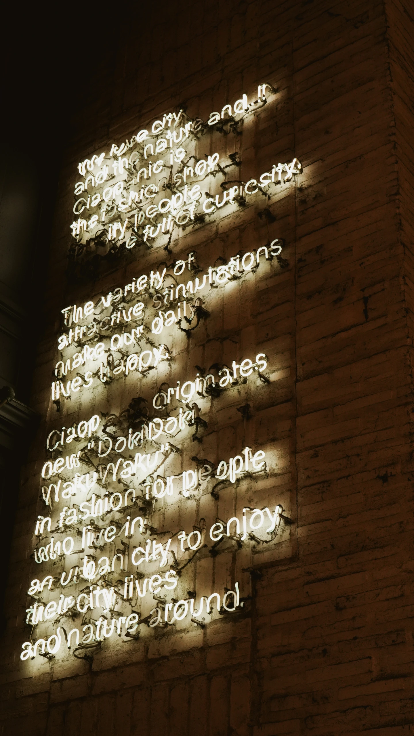 a wall with writing on it that has the wording in many languages projected by various types of lighting