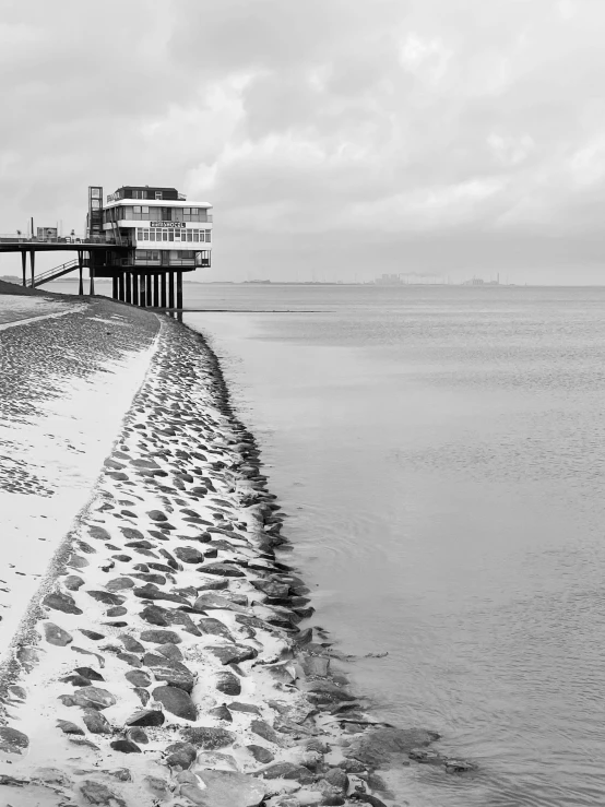 the beach is lined with seagulls and an ocean front pier