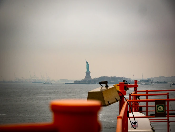 the statue of liberty is seen from a boat traveling in the ocean