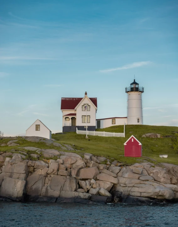 lighthouse on island next to water in open area