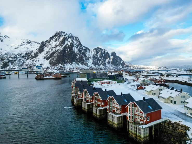 a group of houses sitting next to a mountain