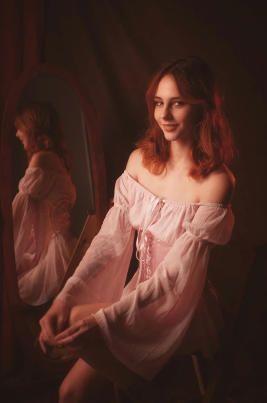 a young woman wearing a dress and sitting in front of a mirror