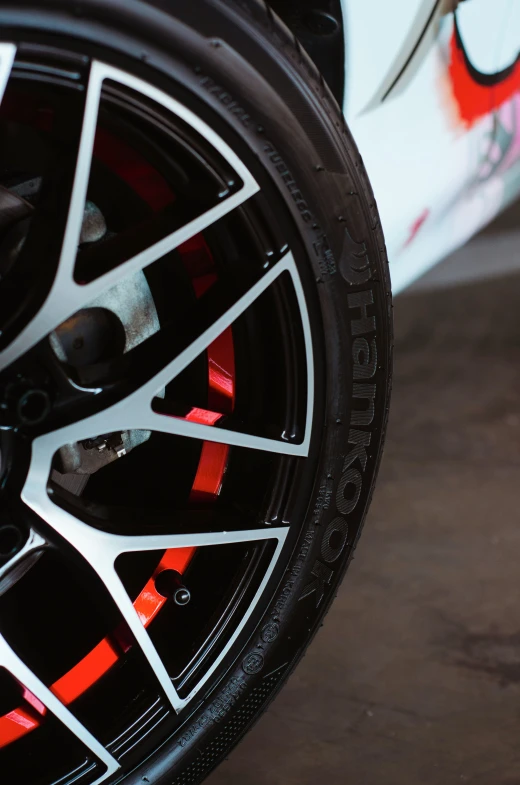 a close up of a tire on a sports car