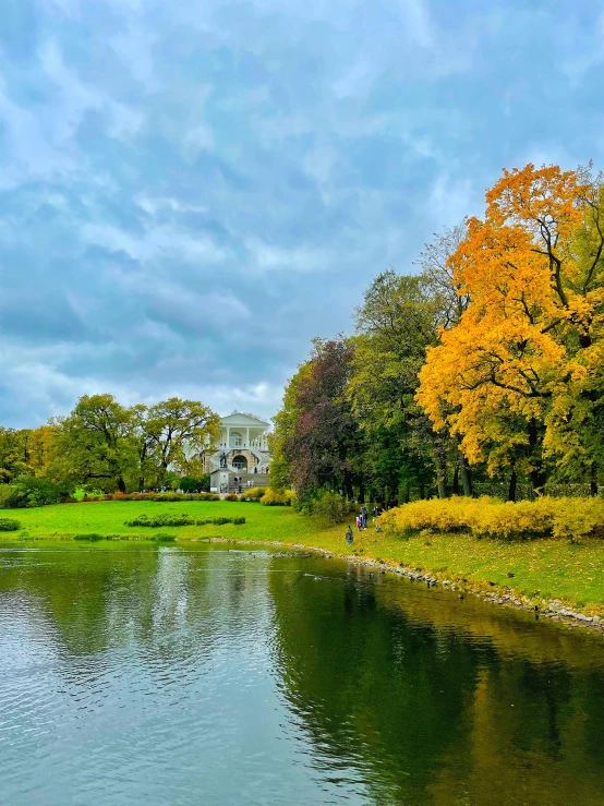 a house surrounded by trees near the water