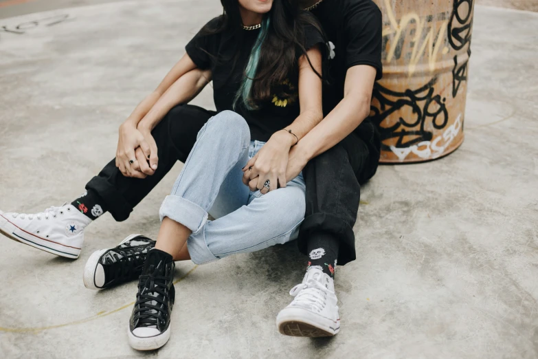 a man and a woman sitting on the ground