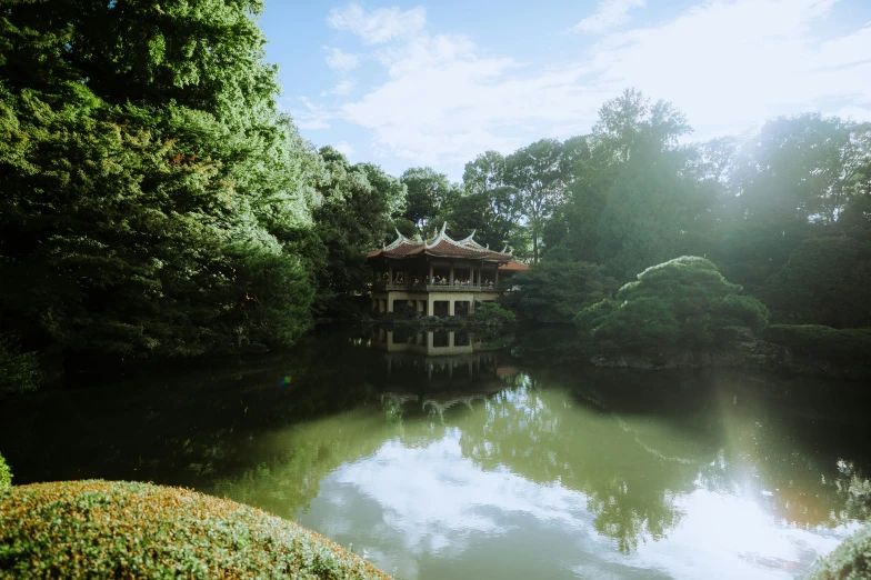 the water near a house is clear and reflecting trees