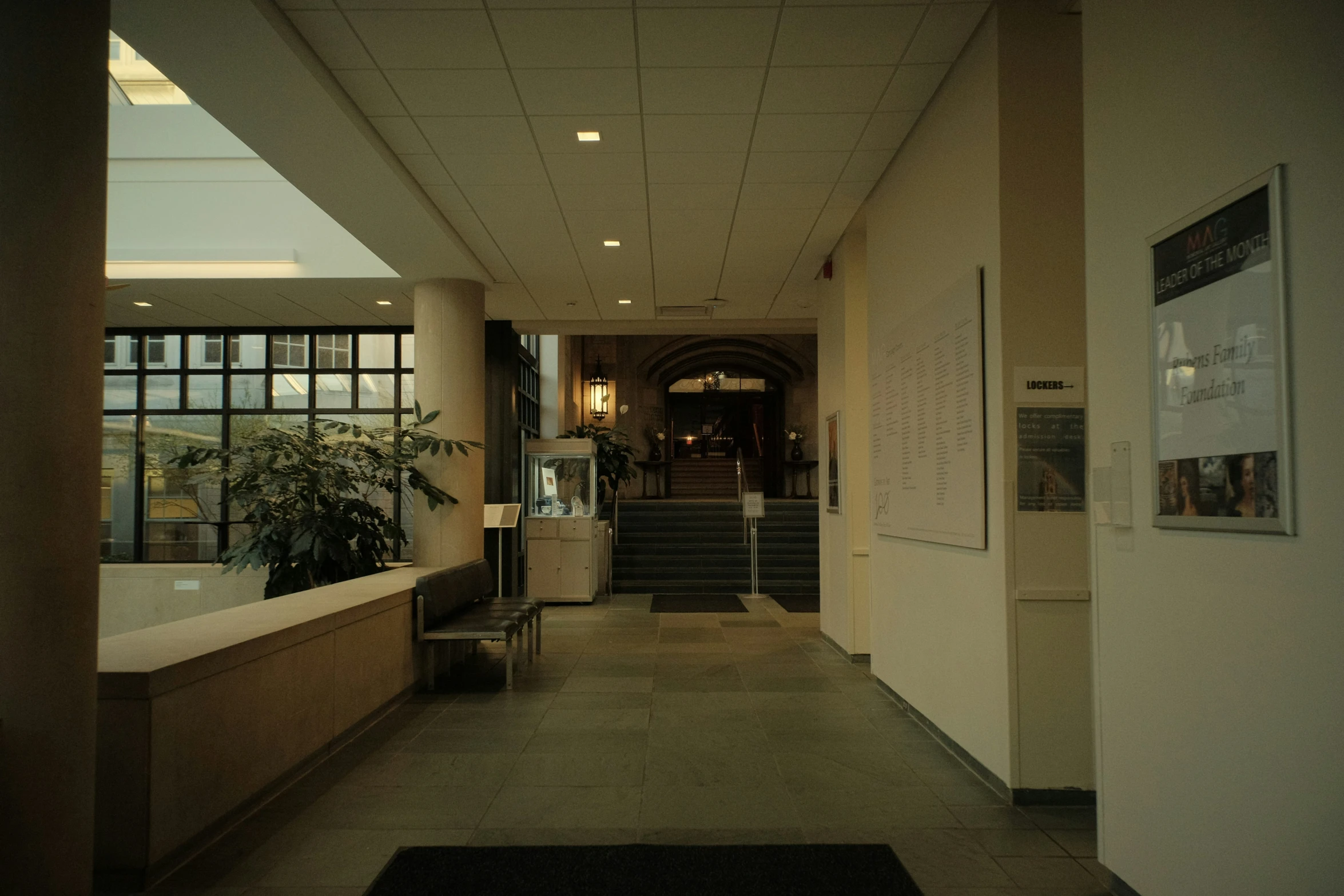 a hallway with lots of large windows and lots of decorations on the walls