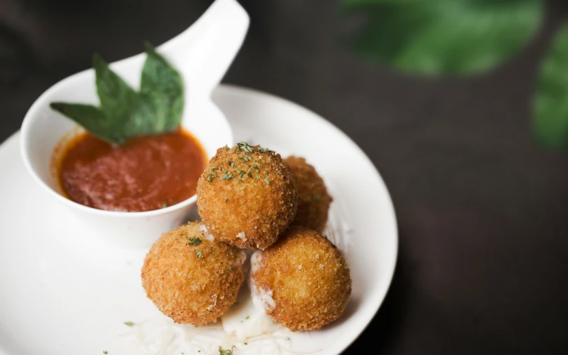 some fried food on a plate with dipping sauce