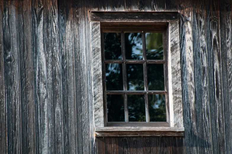 a window is made out of wood near the wall