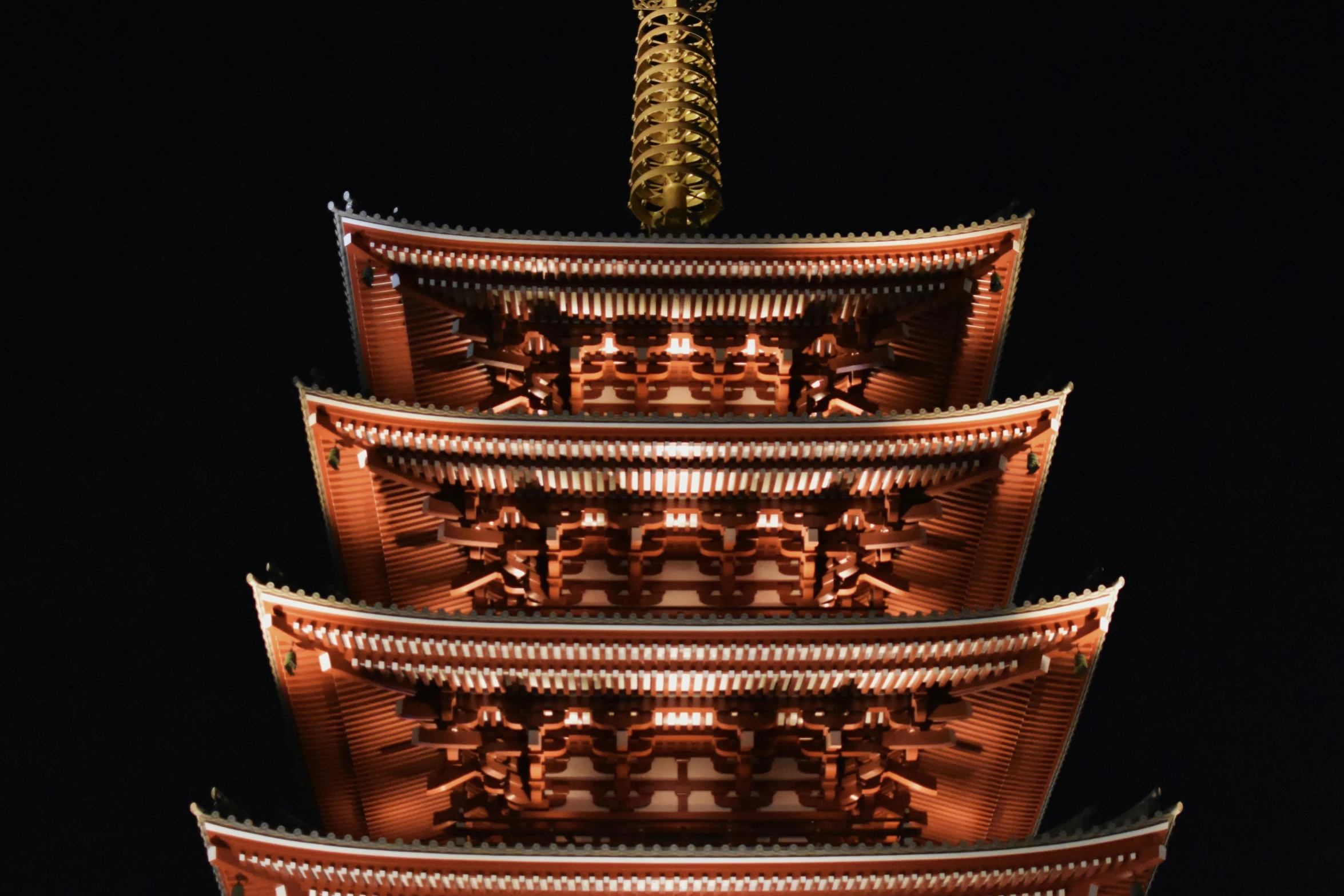 a tall tower with an oriental design at night