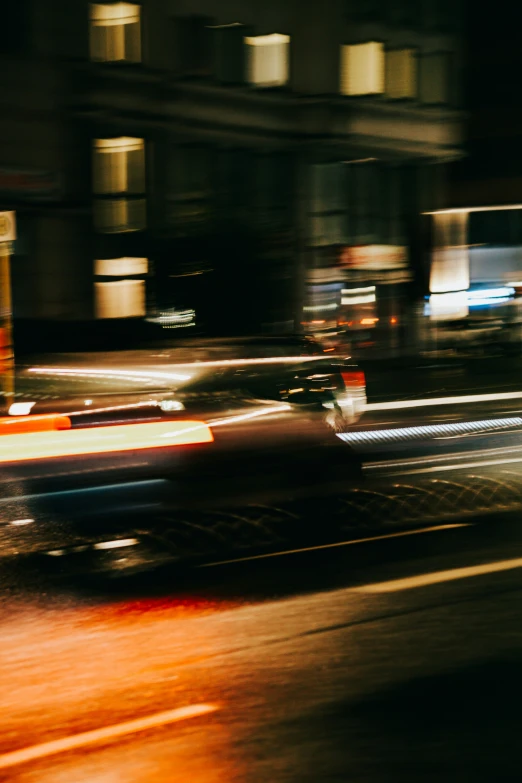 blurred image of city street with cars and buildings