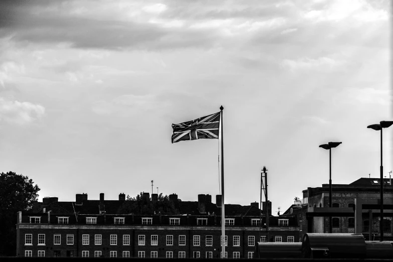 an old flag flying in front of an english town