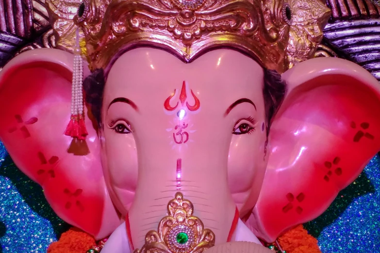 closeup of elephant statue with head covered in gold