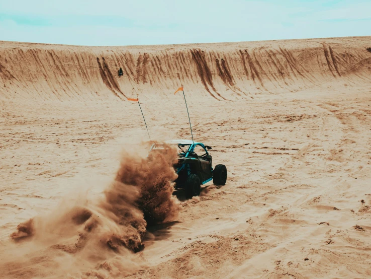 the car is making a sharp turn as it drifts down the sand