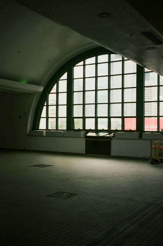 a window has a large arched design and bright windows