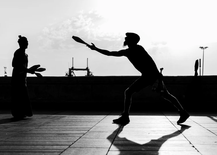 two men playing frisbee on a roof top